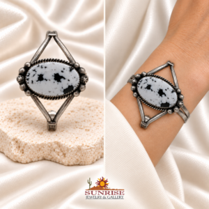 White Buffalo split-shank cuff on pale rock and worn on a wrist
