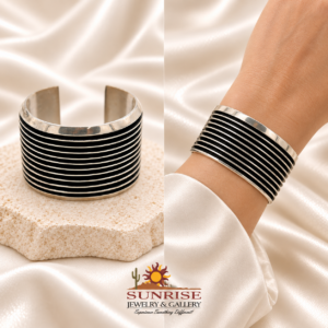 Tom Hawk sterling silver cuff on ivory satin and shown on a wrist